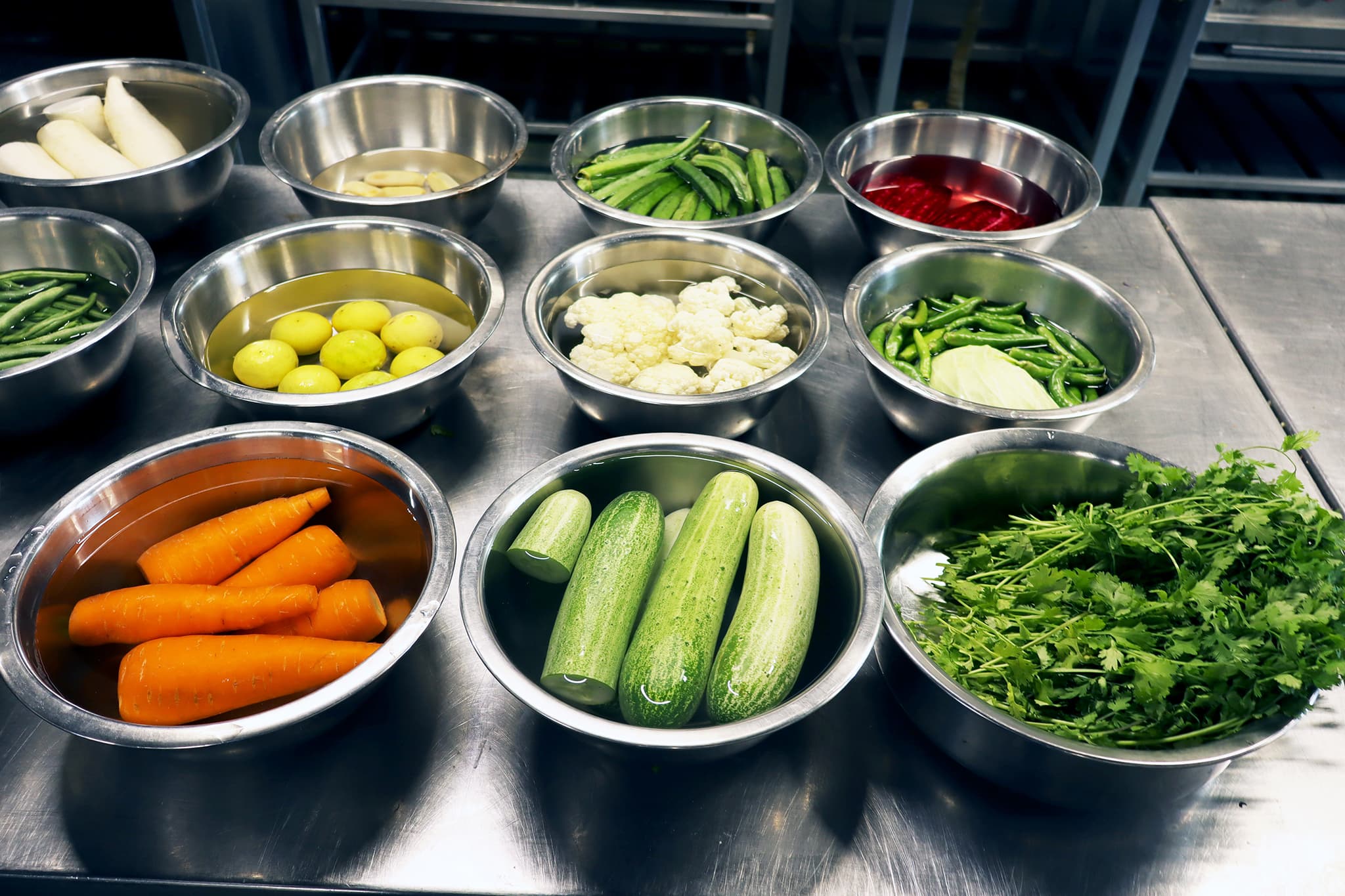 Fresh vegetable preparation area with portioned bowls